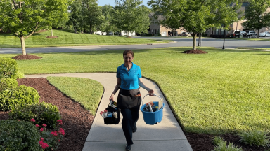 Angela Brown the House Cleaning Guru arrives at a home with cleaning supplies